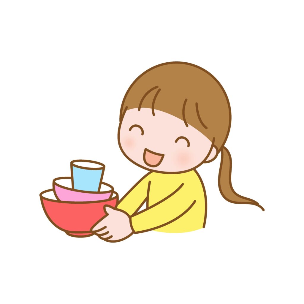 食事の後の食器の片づけをする子
